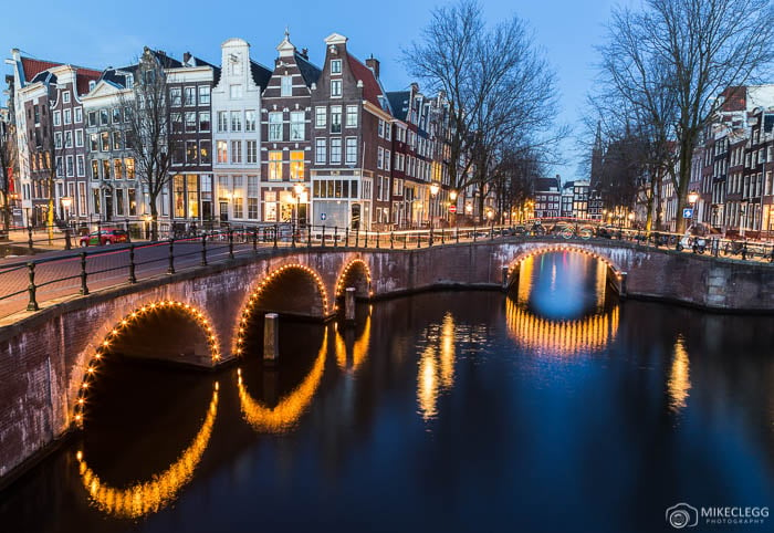 Amsterdam canals, bridges and buildings at night