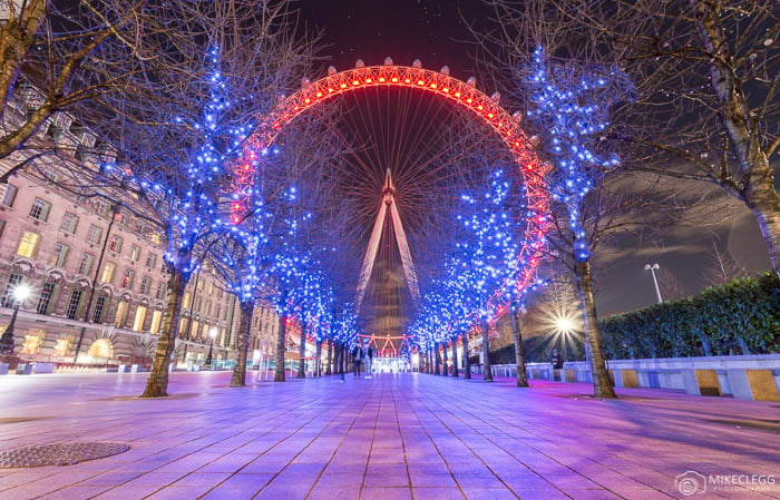 London Eye at night showing colourful lights