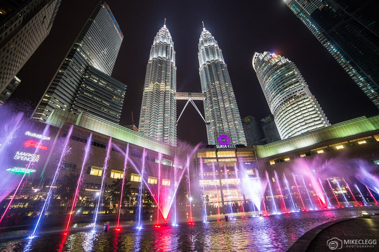 Light show outside Suria KLCC and Petronas Twin Towers at night