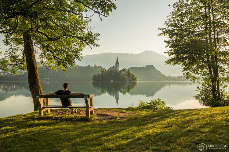 Man sitting alone by Bled Lake