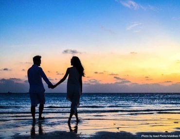 Couple holding hands on a beach