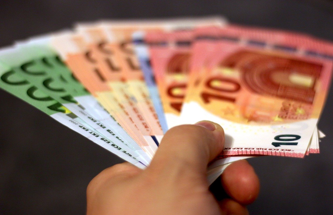 A hand holding bank notes