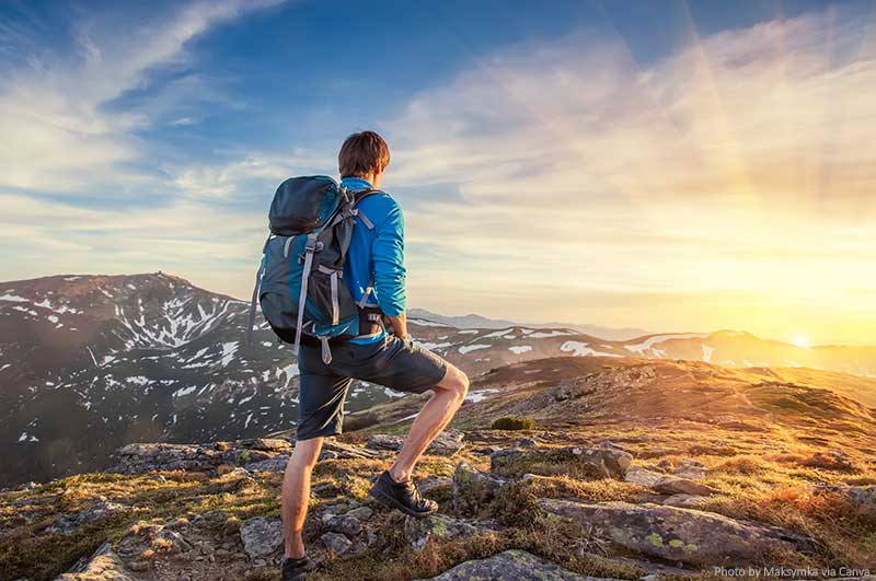 Backpacker on top of a mountain