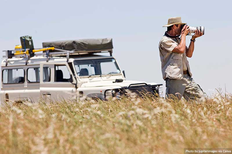 Man on a safari taking pictures