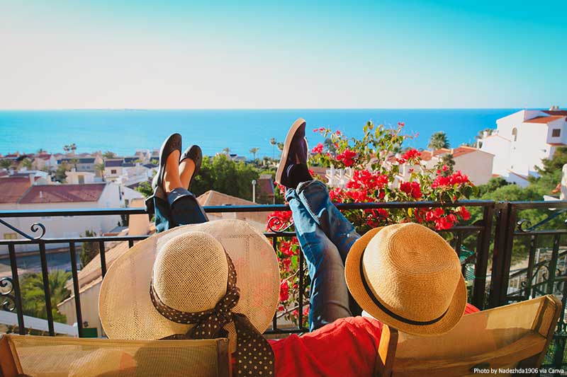 Couple relaxing on a balcony with scenic views