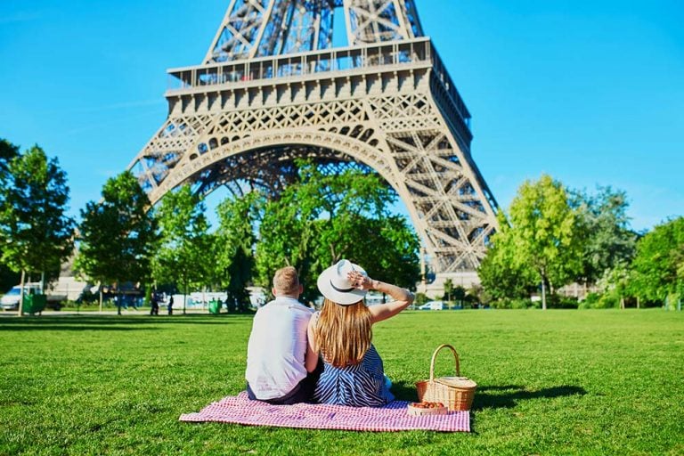 A couple having a picnic near the Eiffel Tower
