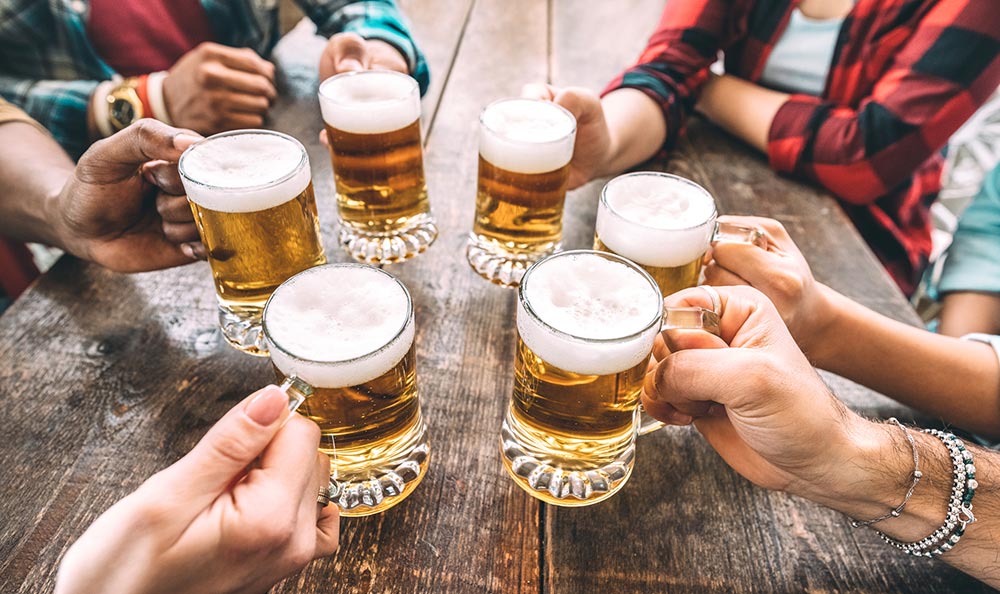 People toasting beer glasses