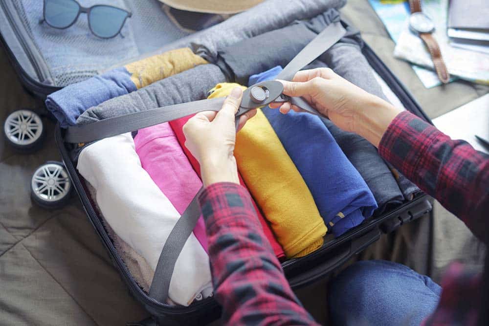 Packing suitcase with rolled clothes