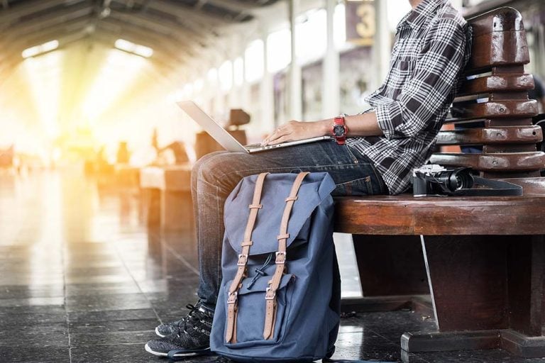 man on a laptop in an airport